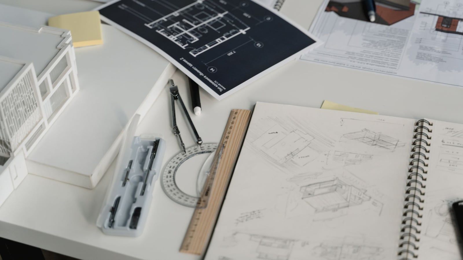 A professional notebook and tablet on a studio desk for project planning.