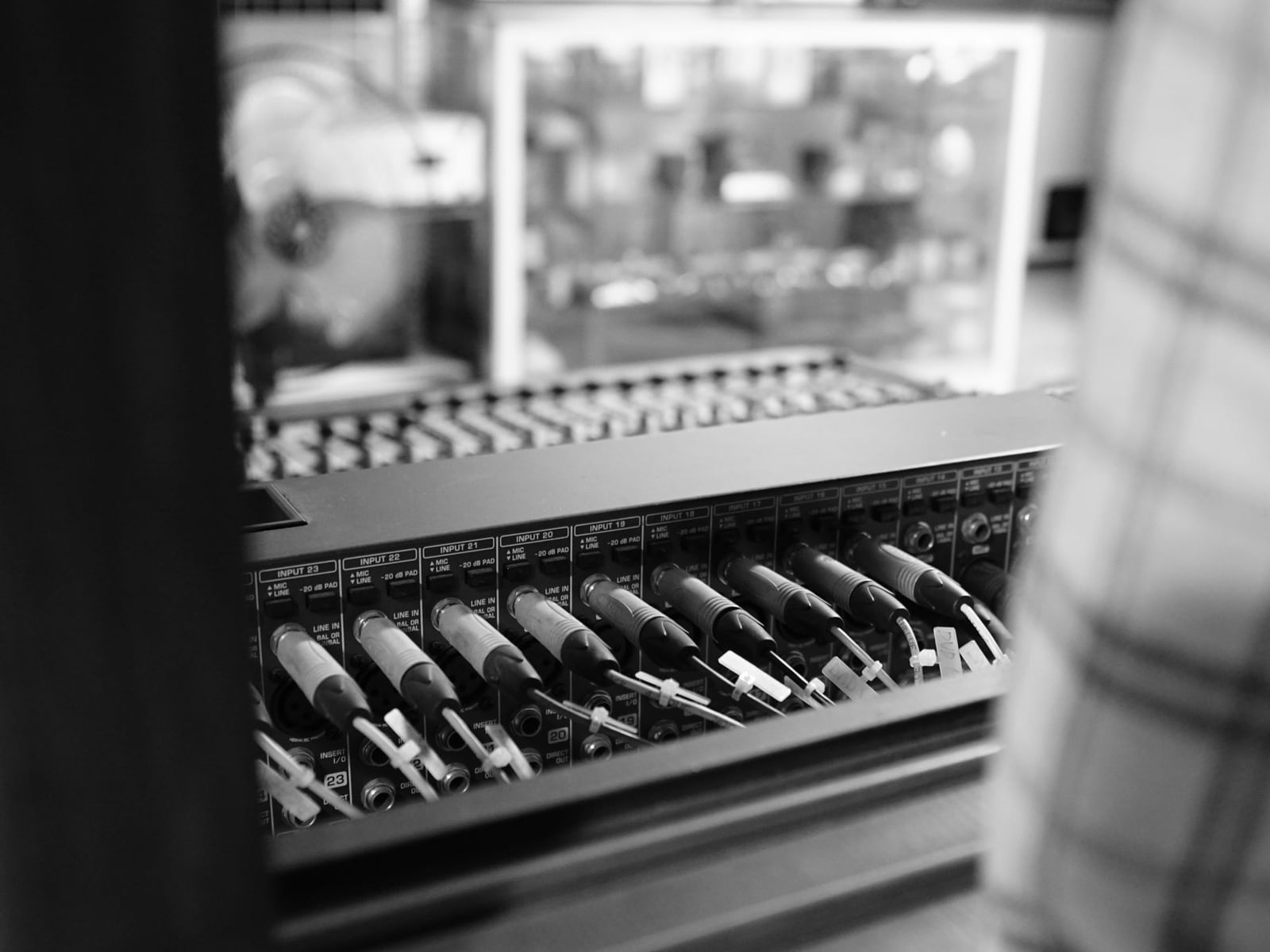 Detail of professional audio patch cables and interface in a recording studio.